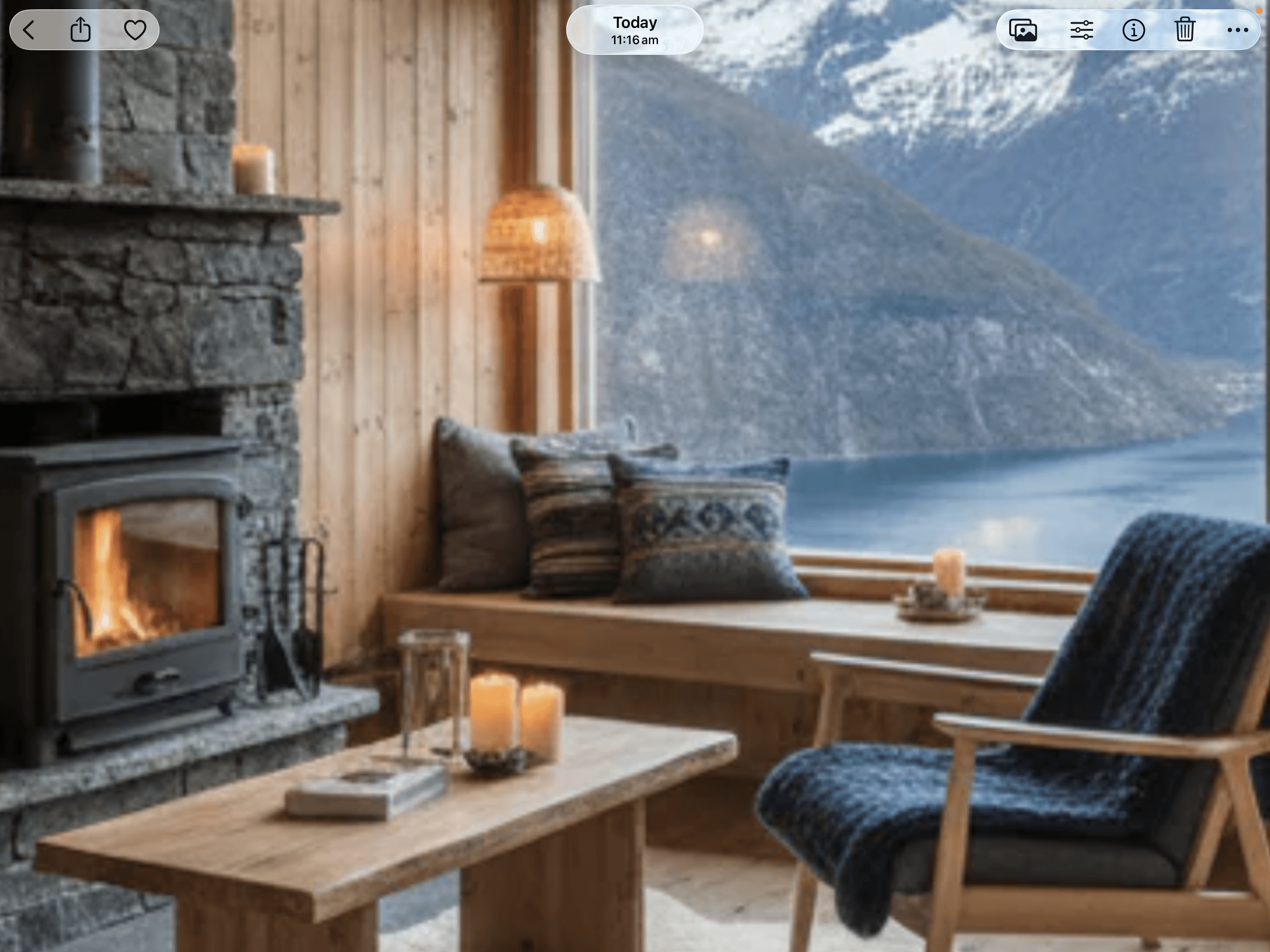 Cozy wooden cabin interior with a fireplace and large window overlooking a scenic mountain lake.